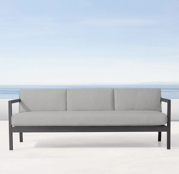 Long grey seat cushion and three back cushions on a sofa in Perth Outdoor Cushions' three-seater reference image.